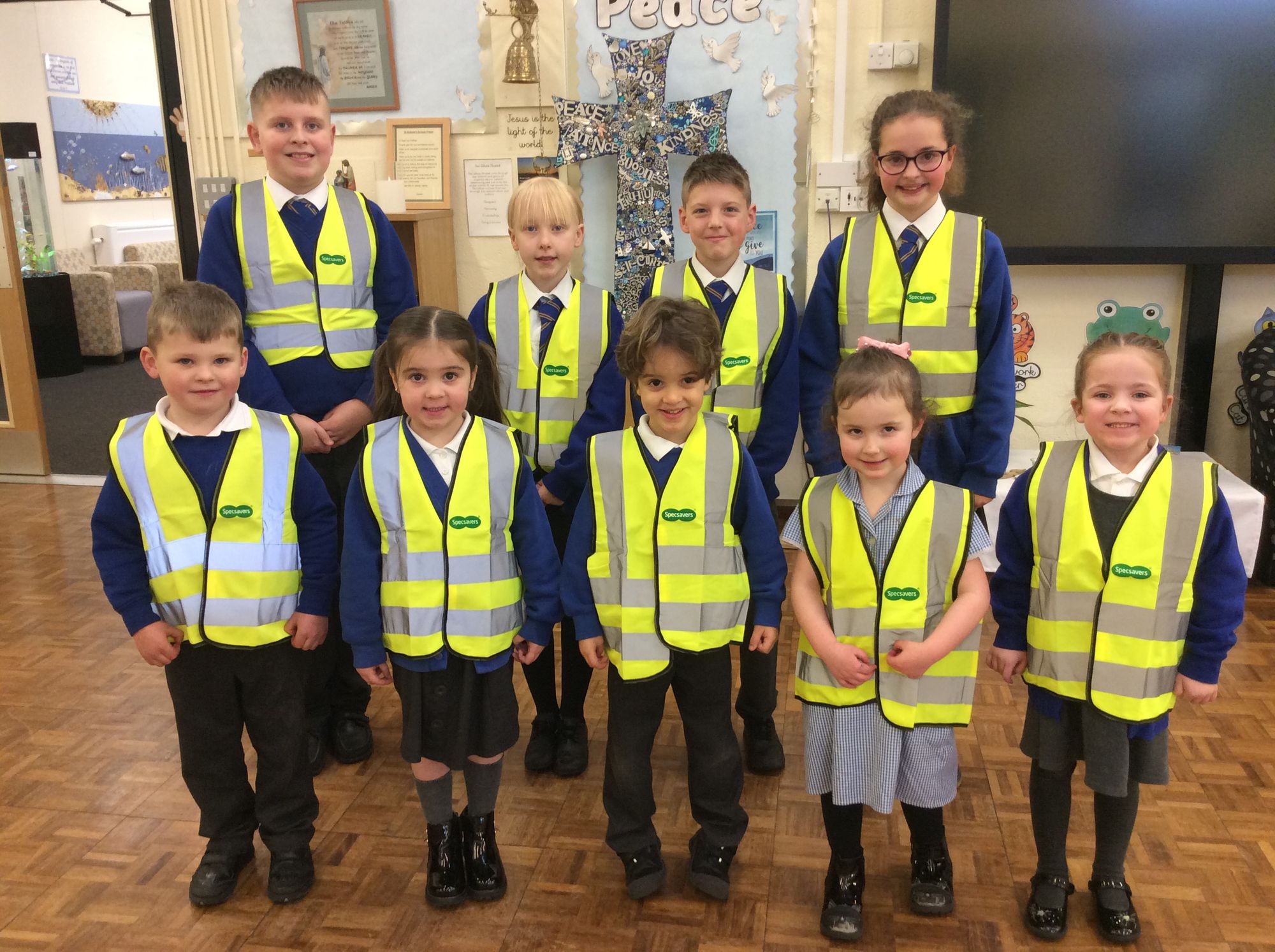 Rochdale opticians donate high visibility vests to local children