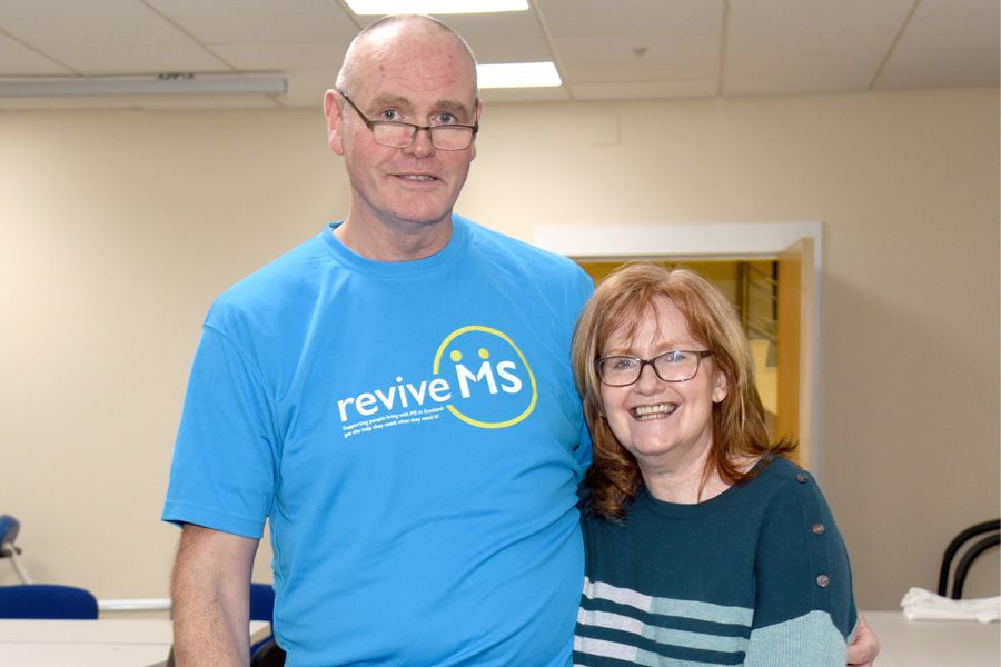 Johnstone funeral director walks over hot coals for people with Multiple Sclerosis