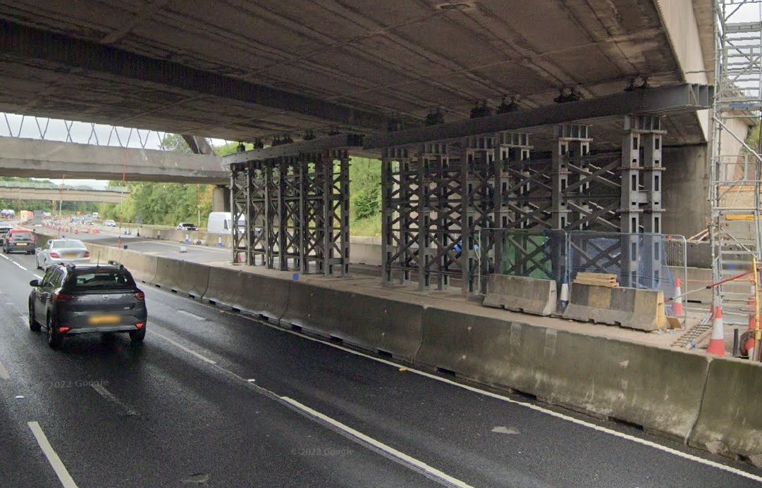 Why was the bridge over the M56 rebuilt?