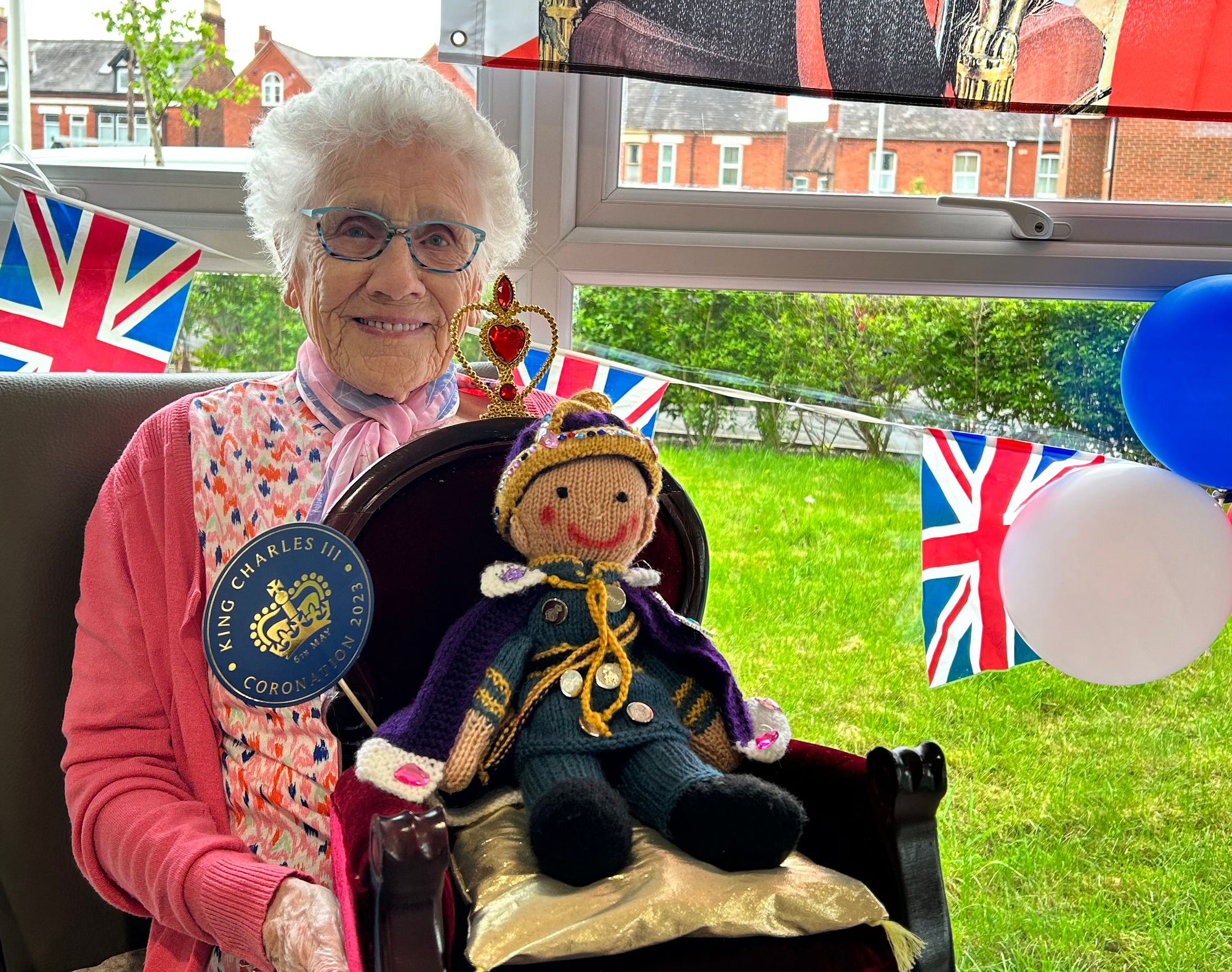 Thelma, 95, celebrates third coronation in her lifetime with royal-themed knitted creations