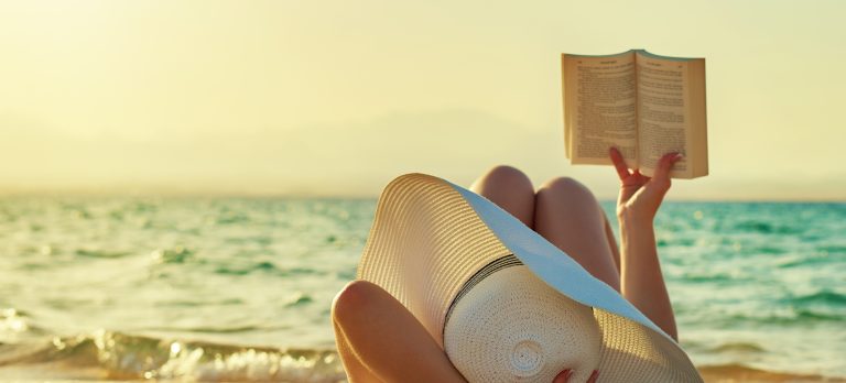 1192173 gs woman reading on beach 474868512 getty