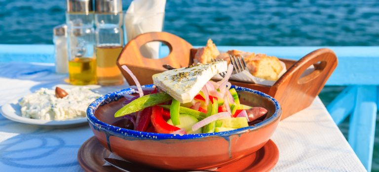782792 greek tavern with blue sea water 652384634 getty