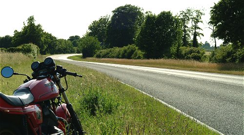 A dry road, a sunny day, a fast corner, an Italian bike...