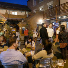 The Black Swan courtyard at night bustling with people