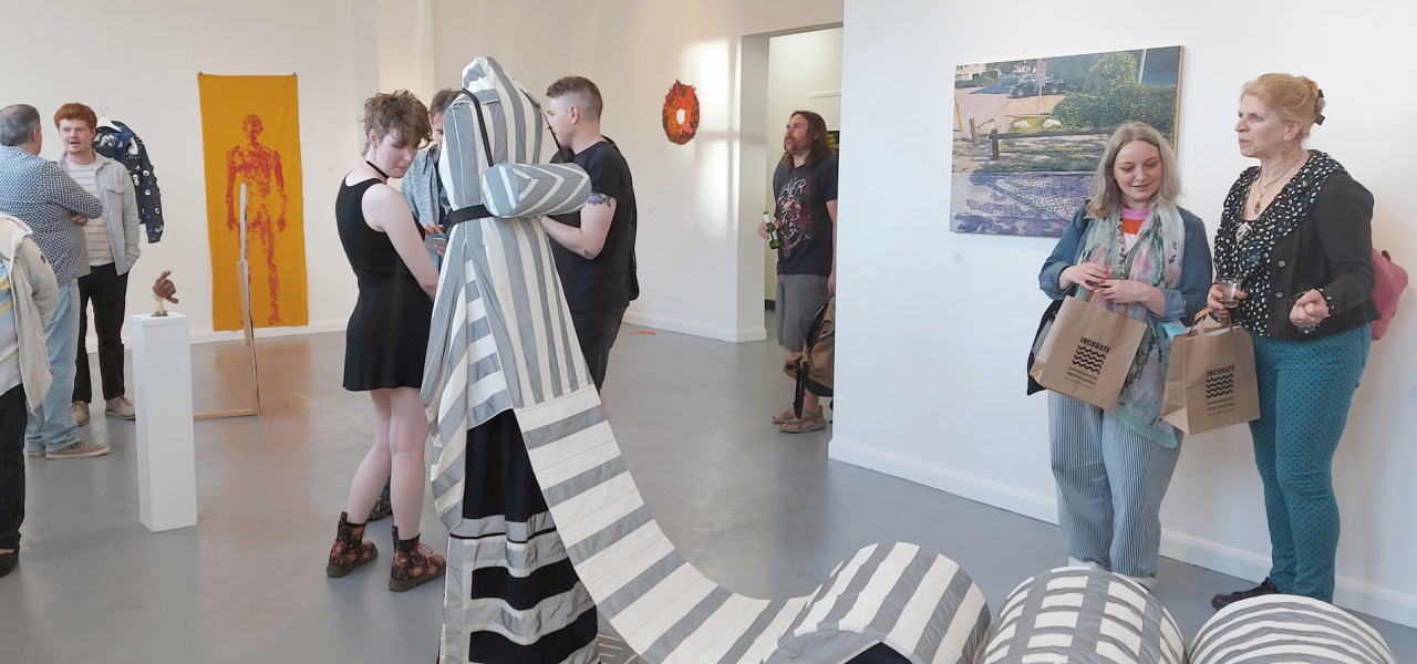 Gallery with art on walls and sculpture in the center of the room