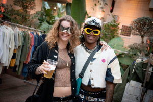 Couple wearing sunglasses, smiling at camera - TLS 2024 (c) Colin Davison