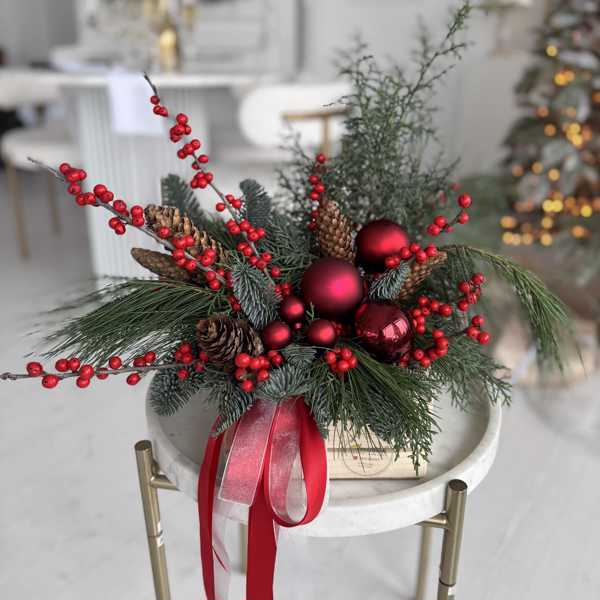 Рождественская композиция из илекса, зимнего декора и шишек