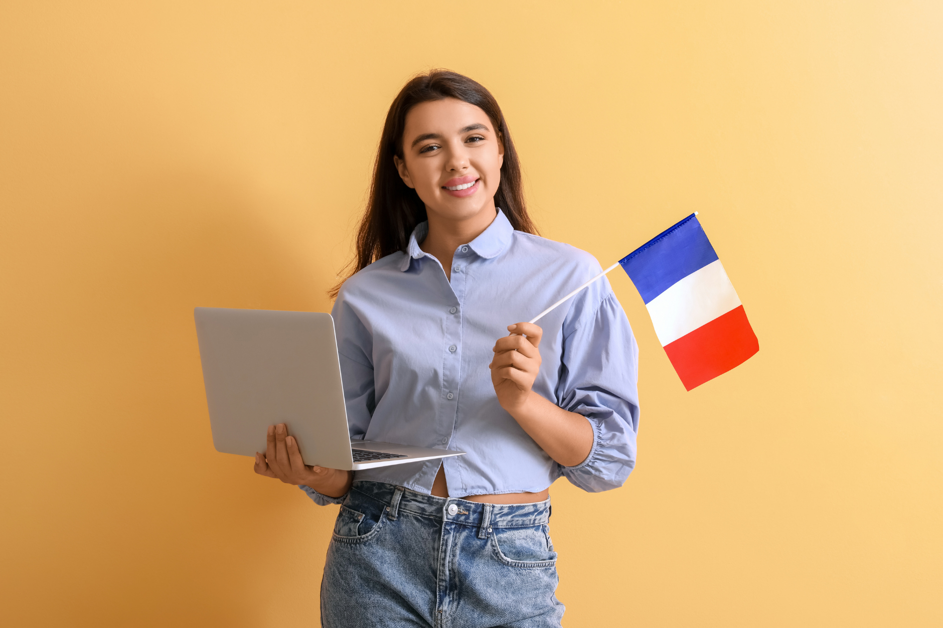 Young woman holding a laptop and the French flag