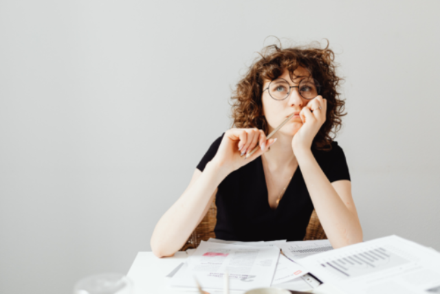 Bespectacled woman deep in contemplation