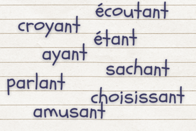Different French present participles written on notepaper