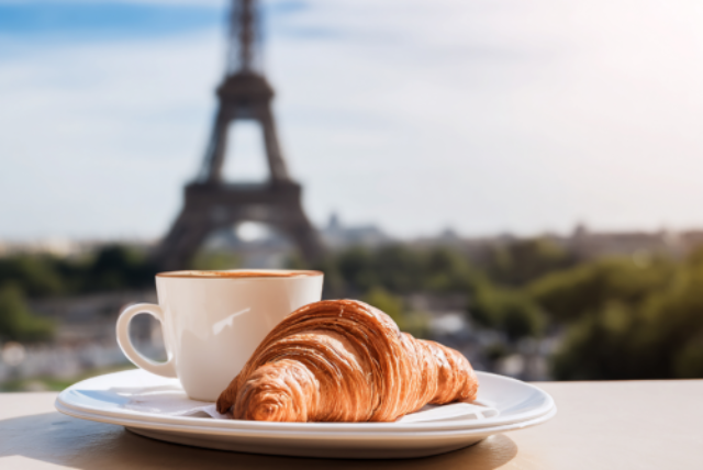 A croissant and coffee with the Eiffel Tower in the background