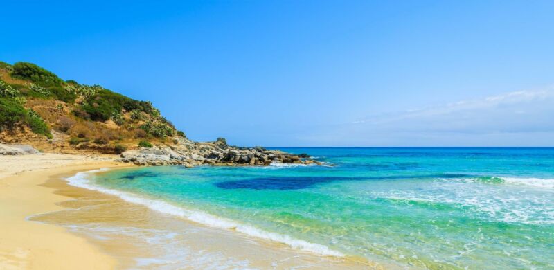 Crystal Clear Water Of Cala Sinzias Beach Sardinia Island Italy