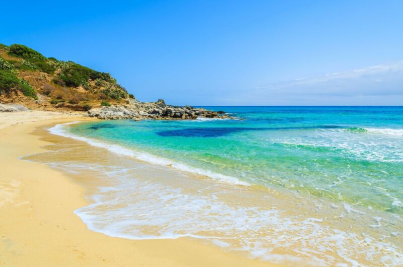 Crystal Clear Water Of Cala Sinzias Beach Sardinia Island Italy