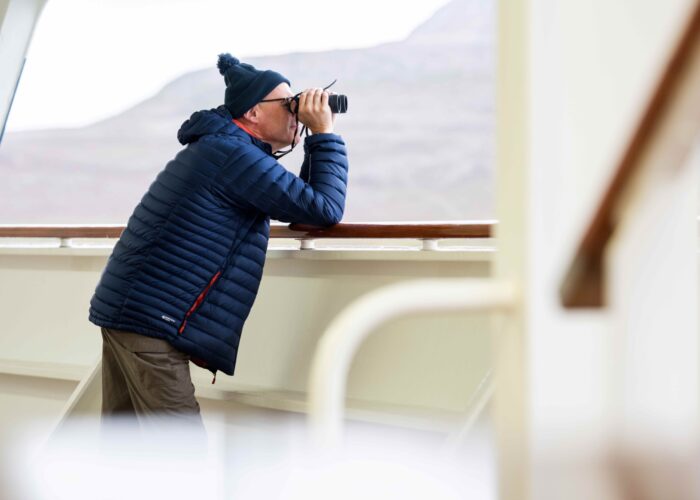 Guest looking out to see with binoculars Bolette resized