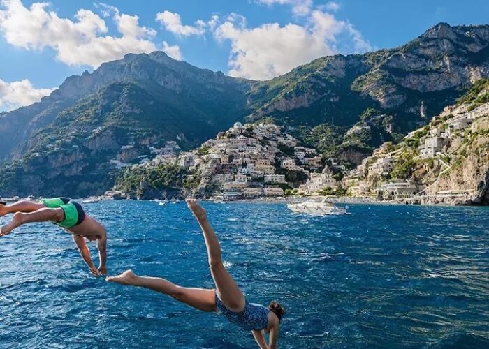 Italy naples positano couple jumping ocean