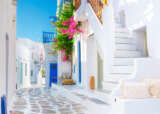 CLG Greece Mykonos Street white and blue houses Getty Images 1390814888
