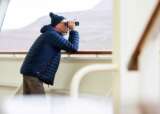 Guest looking out to see with binoculars Bolette resized
