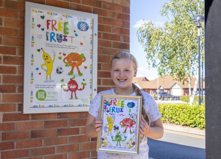 Valerija with her artwork in front of poster