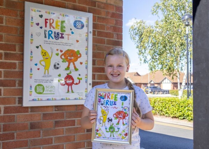 Valerija with her artwork in front of poster