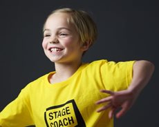 Child in Yellow stagecoach tshirt dancing
