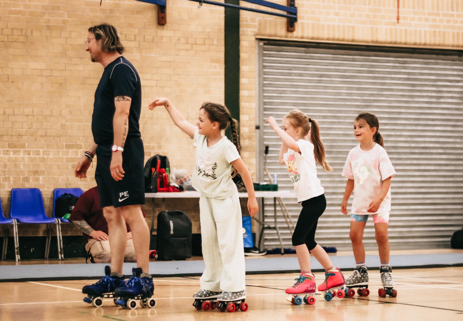 A low down photo of children skating in a hall