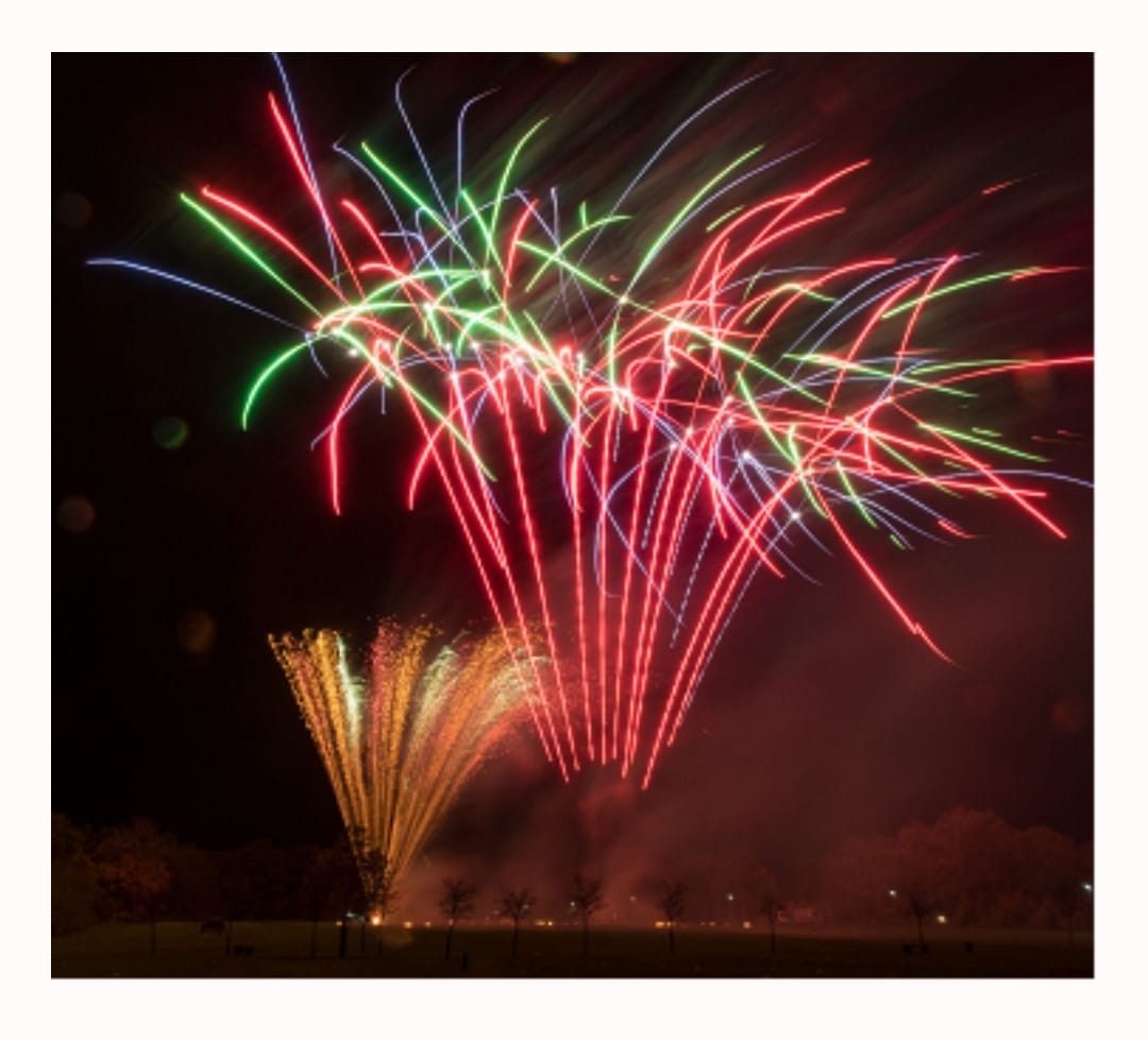 blue poster with white fireworks yellow and blue text saying Wokingham Charity fireworks Spectacular Saturday 4th November 2023