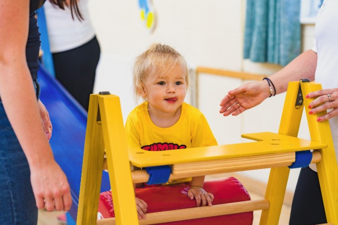 A preschooler walking along a balance beam