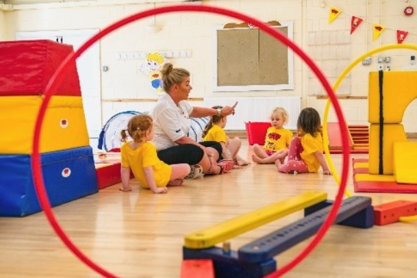 A Baby having tummy time on a bright mat
