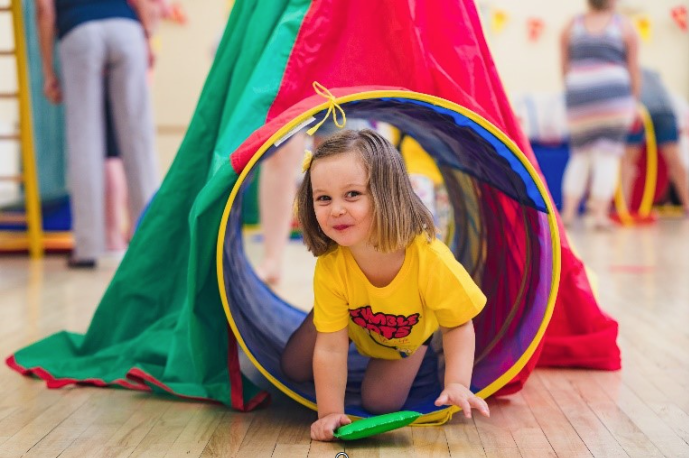 A Baby having tummy time on a bright mat