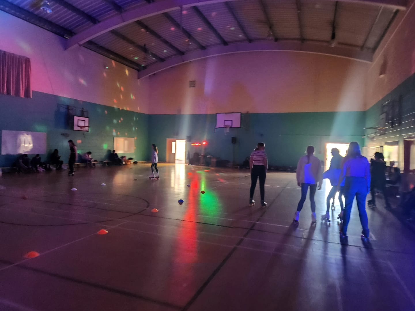 A low down photo of children skating in a hall
