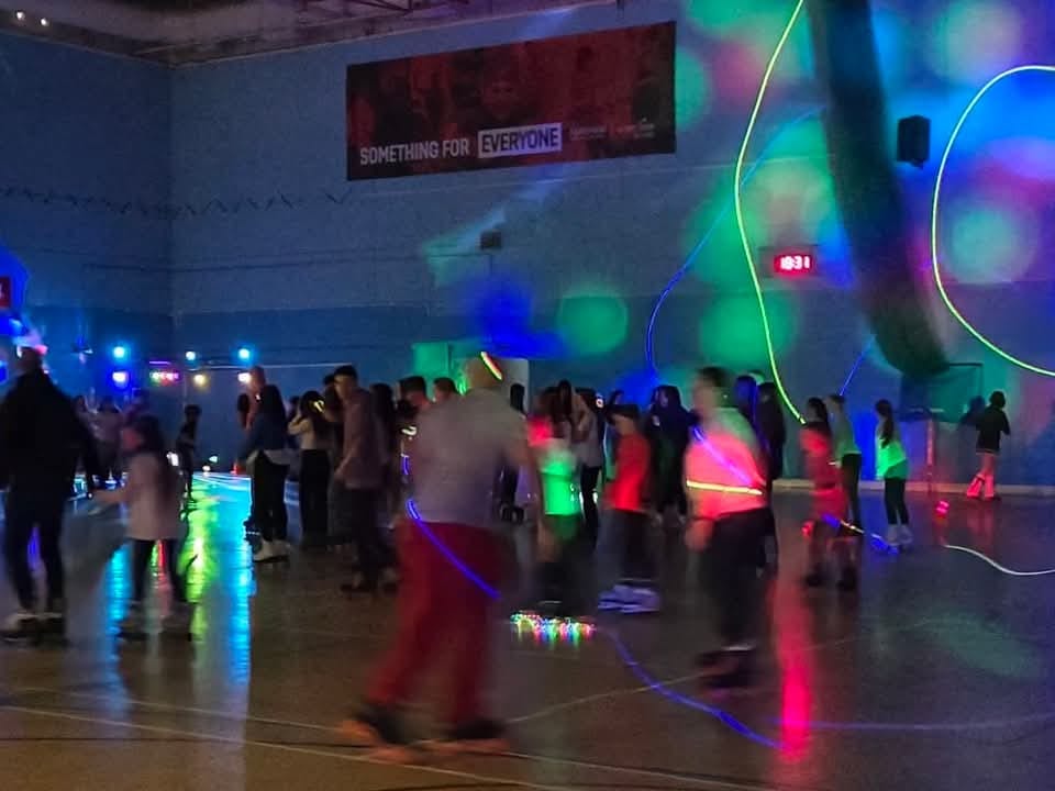 A low down photo of children skating in a hall