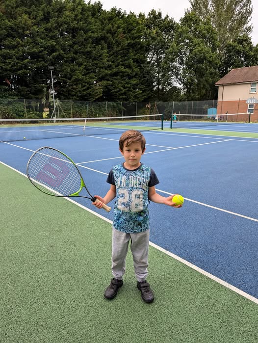 Tennis Balls laid out on the grass spelling out F.L.T.C