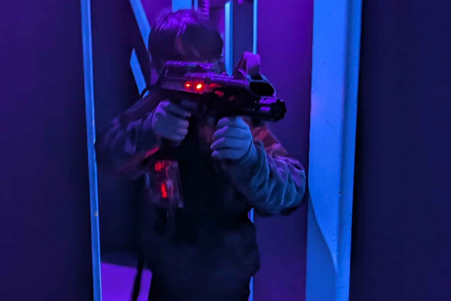 child pointing a lasertag gun
