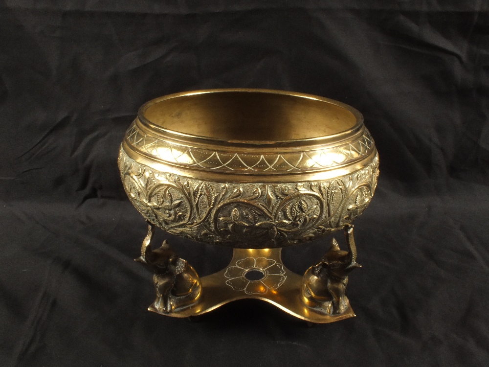 An Indian Brass bowl on three elephant stand
