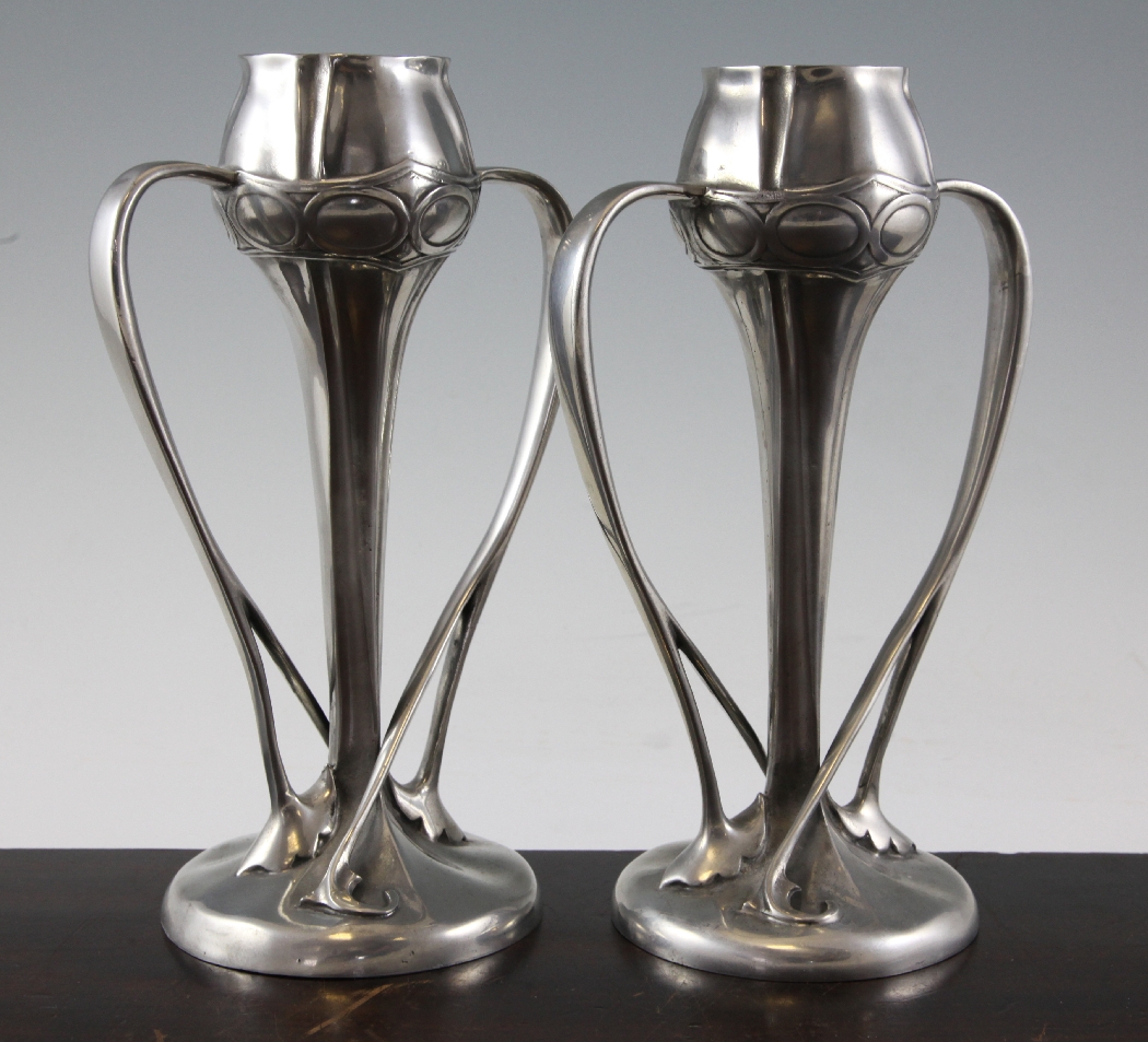 A pair of Liberty Tudric pewter tulip vases, pattern 029, with sinuous
