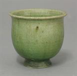 A small earthenware Cup,  Tang dynasty (618-906), of flower bud form on short flared foot, the