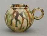 A small Cup,  Tang dynasty (618-906), the globular body irregularly splashed in black ochre and gree