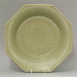 A good celadon Dish,  Yuan/early Ming, of fluted octagonal form, the well diced, the sides carved