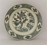 A Zhangzhou Dish, 17th century, painted in a dark underglaze blue with a pheasant on rocks under