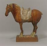 A pottery Horse,  Tang dynasty (618-906), standing four-square under a chestnut glaze, the saddle