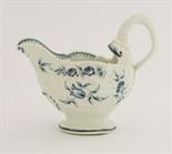 A Worcester blue and white Cream Boat,c.1770, of dolphin ewer type, the rococo shell-moulded