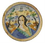 A Spanish maiolica Dish,second half of the 17th century, amusingly painted with a head and exposed