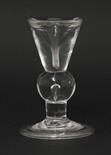 A deceptive baluster Dram Glass,c.1710-1720, with an unusually thick, deceptive conical funnel