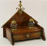 A VICTORIAN WALNUT DESK STAND having a pointed architectural raised back with scrolled brass
