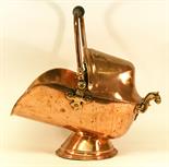 A VICTORIAN COPPER COAL  HELMET with swing over handle^ domed canopy and moulded spreading