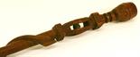 AN EASTERN CARVED HARDWOOD WALKING STICK having a head terminal^ a captive ball with geometric