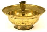 A 19TH CENTURY BRASS CANDLESTICK the substantial dished circular bowl centred by a knopped column
