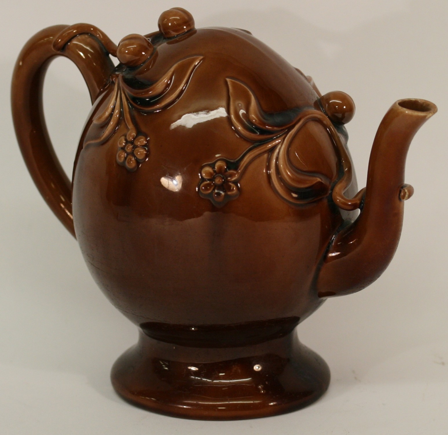 A 19TH CENTURY SPODE TREACLEGLAZED CADOGAN TEAPOT decorated with