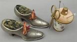 A pair of pewter lady's boot pin cushions with laces and a Halcyon Days enamel sewing set,