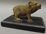 A gilt metal bronze paperweight modelled as a bear upon a rectangular slate plinth, width 10cm.